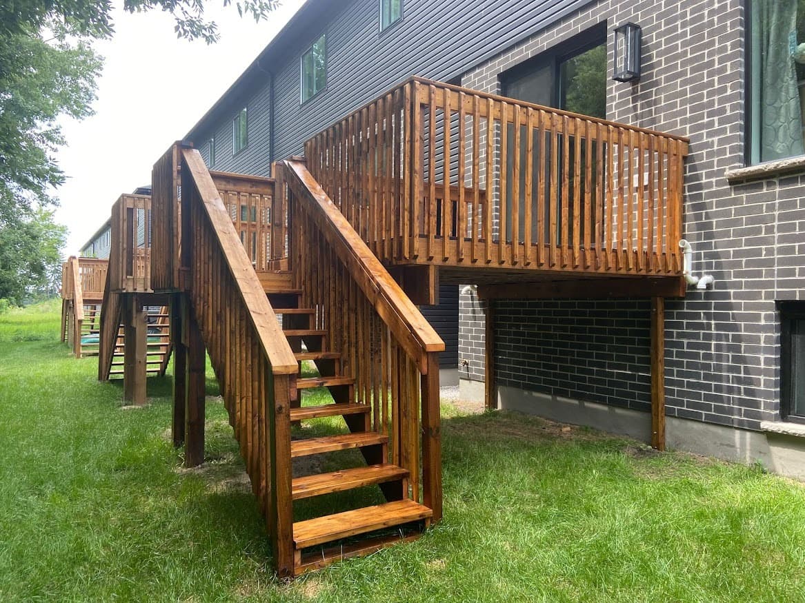 Professional deck staining team at work in Oakville, Ontario